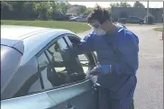  ?? RICHARD PAYERCHIN — THE MORNING JOURNAL ?? An Ohio National Guard medic swabs the nose of a person who came for novel coronaviru­s testing in a drive-thru event held Aug. 24 at Black River Landing in Lorain.