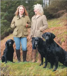  ??  ?? Fiona Woodhouse, right, and her daughter Anna-May with their three black labs, Kyah, Zara and Time.