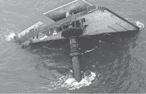  ?? GERALD HERBERT/ AP ?? The capsized lift boat Seacor Power is shown seven miles off the coast of Louisiana in the Gulf of Mexico on Sunday. The vessel capsized during a storm last week.