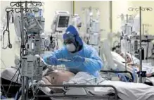  ?? —REUTERS ?? INTENSIVE CARE A health worker sees to a COVID-19 patient at the University of Chile hospital on June 18.