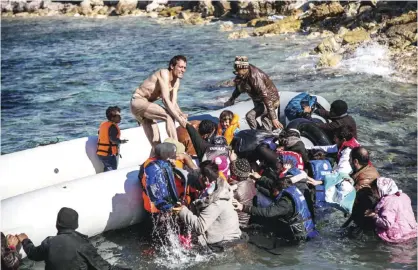  ??  ?? CESME: Migrants and refugees walk towards a dinghy to travel to the Greek island of Chios from Cesme in the Turkish province of Izmir yesterday. Nearly 500 people have died trying to cross the Aegean Sea from neighborin­g Turkey this year, many of them...
