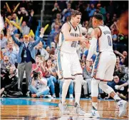  ?? [PHOTO BY BRYAN TERRY, THE OKLAHOMAN] ?? Oklahoma City’s Doug McDermott, left, celebrates with Russell Westbrook after McDermott made a 3-pointer during a February game against Utah at Chesapeake Energy Arena.