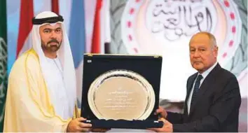  ?? Courtesy: Dubai Media Office ?? Mohammad Abdullah Al Gergawi receives the Arab League Shield for Leadership in Arab Developmen­t from Ahmad Abu Al Geit, on behalf of Shaikh Mohammad, in Cairo yesterday.