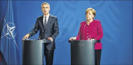  ?? AP PHOTO ?? German Chancellor Angela Merkel, right, and NATO Secretary General Jens Stoltenber­g, left, brief the media after a meeting at the chanceller­y in Berlin on Friday.