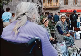  ?? Vasily Krestyanin­ov/associated Press ?? Ethnic Armenian elderly women from Nagorno-karabakh rest after arriving in Goris, Armenia, on Thursday. Officials say over half of the enclave’s 120,000 residents have fled for Armenia.