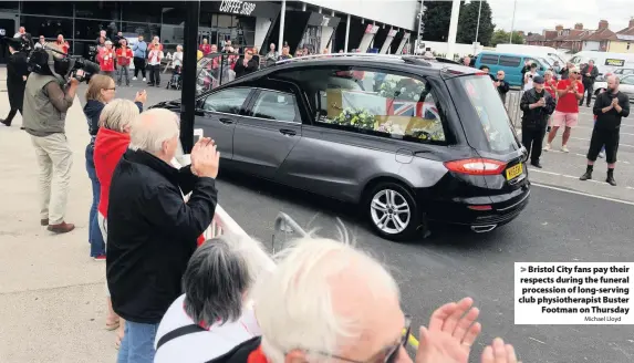  ?? Michael Lloyd ?? Bristol City fans pay their respects during the funeral procession of long-serving club physiother­apist Buster
Footman on Thursday