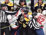  ?? Michael Dwyer / Associated Press ?? The Bruins’ Chris Wagner (14) and the Capitals’ Dmitry Orlov (9) scuffle during the first period Sunday.