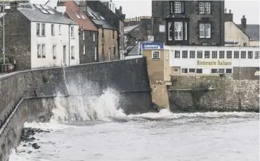  ??  ?? 0 Waves crash in to the sea wall in South Queensferr­y as stormy conditions prevail