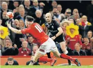  ?? Picture: AFP ?? ON HIS WAY: Wales wing Josh Adams gathers the ball after beating England fullback Elliot Daly to a cross-kick before scoring the final try of the Six Nations rugby match in Cardiff on Saturday. Wales won the game 21-13