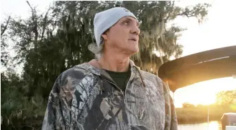  ??  ?? Donald Dardar, a member of the Pointe-au-Chien Indian Tribe, poses in front of a front of a ceremonial mound in marshland off the coast in Louisiana. — Reuters