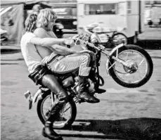  ??  ?? Good mates Barry Sheene and Croxford, doing a wheelie on Sheene’s paddock bike at the Silverston­e Formula 750 round in 1973