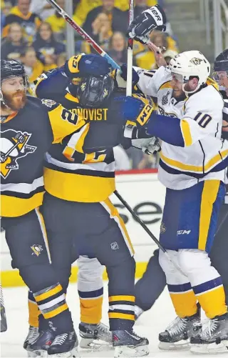  ?? THE ASSOCIATED PRESS ?? Pittsburgh’s Patric Hornqvist, left, and Nashville’s Colton Sissons scuffle during the first period Wednesday night in Pittsburgh. The Penguins won 4-1 to take a 2-0 lead in the best-of-seven Stanley Cup Final.