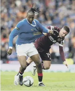  ?? ?? 0 Feisty midfielder Devlin tussles with Rangers’ Joe Aribo