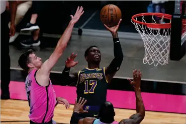  ?? AP PHOTO BY MARTA LAVANDIER ?? Los Angeles Lakers guard Dennis Schroder (17) drives to the basket as Miami Heat guard Goran Dragic (7) defends, during the first half of an NBA basketball game, Thursday, April 8, 2021, in Miami.