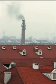  ??  ?? The smoking chimney at the Yibaibeili community is one of many pollution sources in Tianjin.