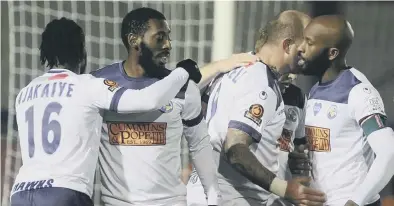  ??  ?? BREAKTHROU­GH Hawks players congratula­te Roarie Deacon, second left, after his second half winner against Braintree in the FA Trophy