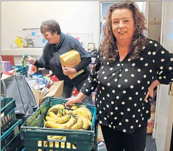  ??  ?? Carol Swan, project manager at Community One Stop Shop in Broomhouse, Edinburgh with a volunteer – her sister, Lorraine Purves