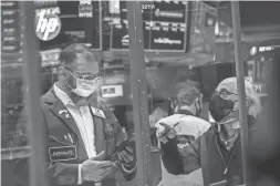  ?? NEW YORK STOCK EXCHANGE VIA AP ?? Traders Aman Patel, left, and Peter Tuchman work on the New York Stock Exchange floor on Friday. Despite a recent pullback in the market, the major stock indexes remain near all-time highs.