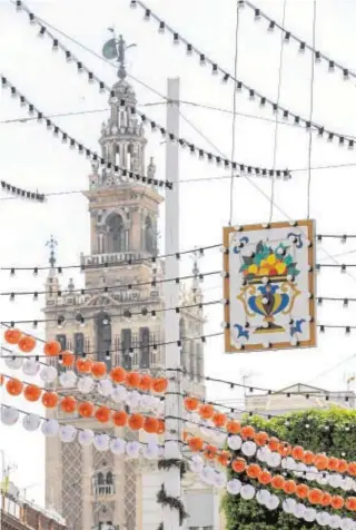  ?? RAÚL DOBLADO ?? El Ayuntamien­to de Sevilla ha colgado los farolillos de la Feria en el centro de la ciudad, cerca de la Giralda, para aliviar la nostalgia de los sevillanos que se quedan otro año sin disfrutar las fiestas