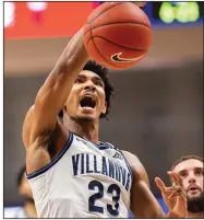  ?? (AP/Laurence Kesterson) ?? Villanova’s Jermaine Samuels finishes a dunk Wednesday night in the No. 10 Wildcats’ 72-60 victory over No. 14 Creighton.