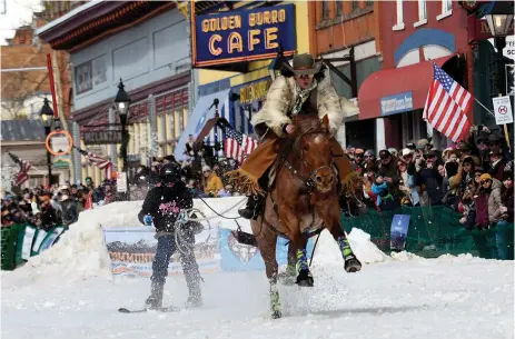  ?? ?? A skijoring team competes in Leadville, Colo., on Saturday, March 2. Skijoring draws its name from the Norwegian word skikjoring, meaning "ski driving."