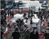  ?? ASSOCIATED PRESS ?? In this June 11 photo, artists paint large letters that read “Black Lives Matter” painted on a street near Cal Anderson Park inside what is being called the “Capitol Hill Autonomous Zone” in Seattle.