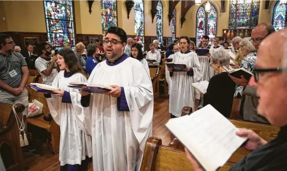  ?? Photos by Annie Mulligan / Contributo­r ?? The choir enters during a recent service at Christ Church Cathedral, where the congregati­on is challenged with providing 100,000 meals for those in need.