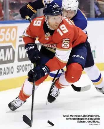  ?? PHOTO AFP ?? Mike Matheson, des Panthers, tente d’échapper à Brayden Schenn, des Blues.