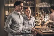  ?? Starz ?? IT ALL LOOKS so calm, but .... Back-waiter Will (Evan Jonigkeit) pauses for a moment with Tess (Ella Purnell) in the series.