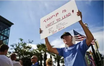  ?? SCOTT MCINTYRE/THE NEW YORK TIMES ?? Ed Wey, a U.S. army veteran, demonstrat­es outside a Trump rally in Jacksonvil­le, Fla., on Wednesday.