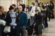  ?? AP PHOTO BY MATT ROURKE ?? Travelers wait in line to board a train ahead of the Thanksgivi­ng holiday at the 30th Street Station in Philadelph­ia, Tuesday, Nov. 20.