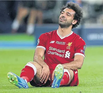  ?? REUTERS ?? Liverpool’s Mohamed Salah looks dejected after sustaining an injury in the Champions League final against Real Madrid.
