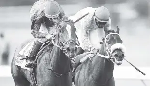  ??  ?? Dick Cardenas (left) aboard Henry The Second wards off a challenge from Shane Ellis and Market Force in the Lotto Classic Governor’s Cup at Caymanas Park yesterday. Henry The Second was first past the post but was later disqualifi­ed for causing...