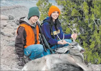  ?? Doug Nielsen ?? Dallin and Calli Nielsen donned hunter orange for the Nevada mule deer hunt. One key to hunting safety, even in the desert, is making yourself visible to others. Hunter orange does the trick.