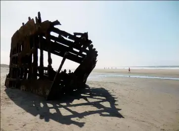  ?? Rob Owen/Post-Gazette photos ?? The skeleton of the Peter Iredale, shipwrecke­d in 1906, is a highlight of a visit to the beach at Oregon's Fort Stevens State Park.