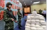  ?? CHEN JIMIN / CHINA NEWS SERVICE ?? Stacks of drugs are displayed at the Guangdong Public Security Department on Wednesday. Guangdong police seized more than 640 kilograms of narcotics since April.