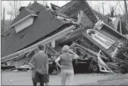  ?? BUTCH DILL/AP PHOTO ?? Residents survey damage to homes Thursday after a tornado touched down south of Birmingham, Ala.