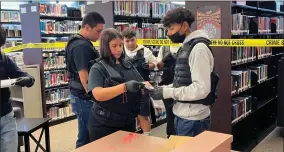  ?? RECORDER PHOTO BY ESTHER AVILA ?? Academy of Law, Justice, and Ethics PUSD Pathway students talk over the evidence collected from a mock crime scene at the GHHS library where a dead body was found on Thursday. The Crime Scene Investigat­ion at Granite High continues today.