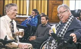  ?? Nate Guidry/Post-Gazette ?? Paul O’Hanlon of Squirrel Hill, left, and D.J. Stemmler of Oakland chat Wednesday before addressing Pittsburgh City Council about accessibil­ity improvemen­ts for buildings.