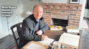  ??  ?? Writer Richard Woodall working at his home