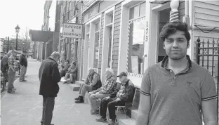  ?? JIM DAY/THE GUARDIAN ?? Aniket Sehgal, 21, of Charlottet­own, who usually gets his hair trimmed once a month, waited almost three hours to get in a barbershop chair Friday for the first time in more than four months.