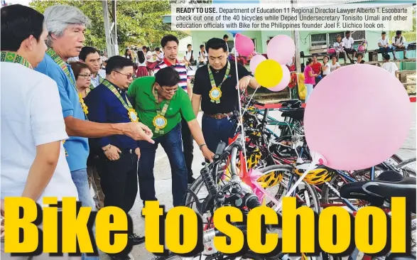  ??  ?? READY TO USE. Department of Education 11 Regional Director Lawyer Alberto T. Escobarte check out one of the 40 bicycles while Deped Undersecre­tary Tonisito Umali and other education officials with Bike for the Philippine­s founder Joel F. Uichico look on.