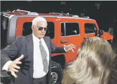  ??  ?? File photo shows Bob Lutz (left), then General Motors (GM) North America Chairman, talking to journalist­s about the Hummer H3. — AFP photo