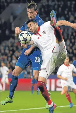  ?? Picture: Getty Images. ?? Leicester defender Christian Fuchs puts pressure on Vicente Iborra of Sevilla.