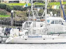  ?? PHOTO: PROVISION ?? Officers carry out a forensic search of the yacht at Castlepark Marina in Kinsale.