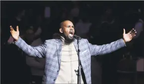  ?? Frank Franklin II / Associated Press file photo ?? Musical artist R. Kelly performs the national anthem before an NBA basketball game between the Brooklyn Nets and the Atlanta Hawks in New York on Nov. 17, 2015. The dilemma of separating the sides of R. Kelly, who faces 10 counts of aggravated sexual abuse, now confronts millions who listen to or perform his music.