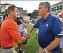  ?? HYOSUB SHIN / HSHIN@AJC.COM ?? Tech coach Paul Johnson, shaking hands with Dabo Swinney last Saturday, fell to 1-3 after losing to Clemson.