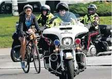  ??  ?? Shannon Birkmann received a police escort through Calgary Thursday as she completed the first leg of her trip across Canada in support of the Alberta and Northwest Territorie­s chapter of Children’s Wish Canada.