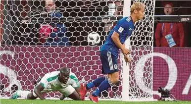  ?? REUTERS PIC ?? Japan’s Keisuke Honda celebrates scoring their second goal against Senegal on Sunday.