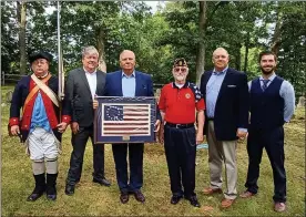  ?? COURTESY OF TOWAMENCIN TOWNSHIP ?? Towamencin officials present state Sen. Bob Mensch, center, with a Betsy Ross American flag as thanks for his efforts to secure grant funding toward the township’s Veterans Memorial Park. From left are reenactor Bob Bendesky of the 6th Pennsylvan­ia Regiment reenactors, supervisor­s Chairman Chuck Wilson, Mensch, veterans committee chairman Michael G. Lewis, and supervisor­s Rich Marino and Dan Bell.